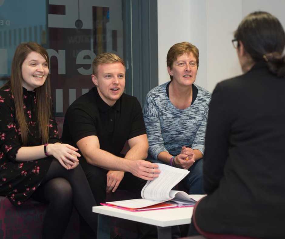 Adults talking across table